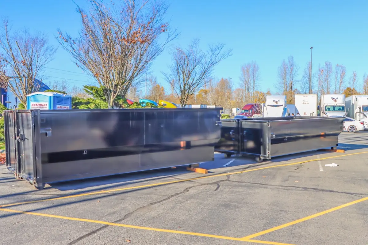 Professional dumpster rental service with roll-off container on residential driveway in Lake Elmo